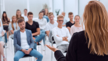 woman talking in front a group